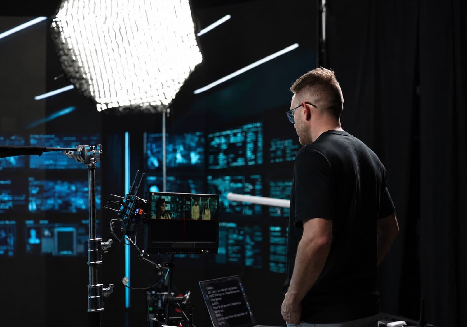 A Griffith Media crew member watching a shot on a director's monitor on set
