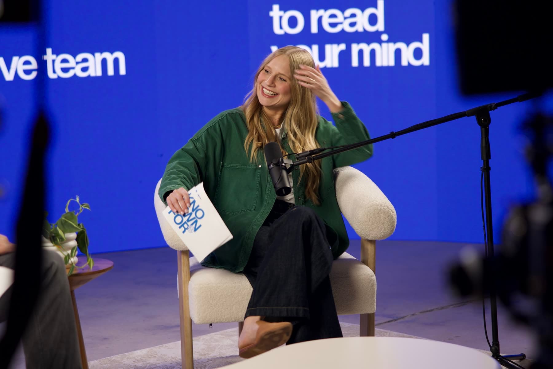 Grace Griffith laughing on the Known For podcast set, notes in hand