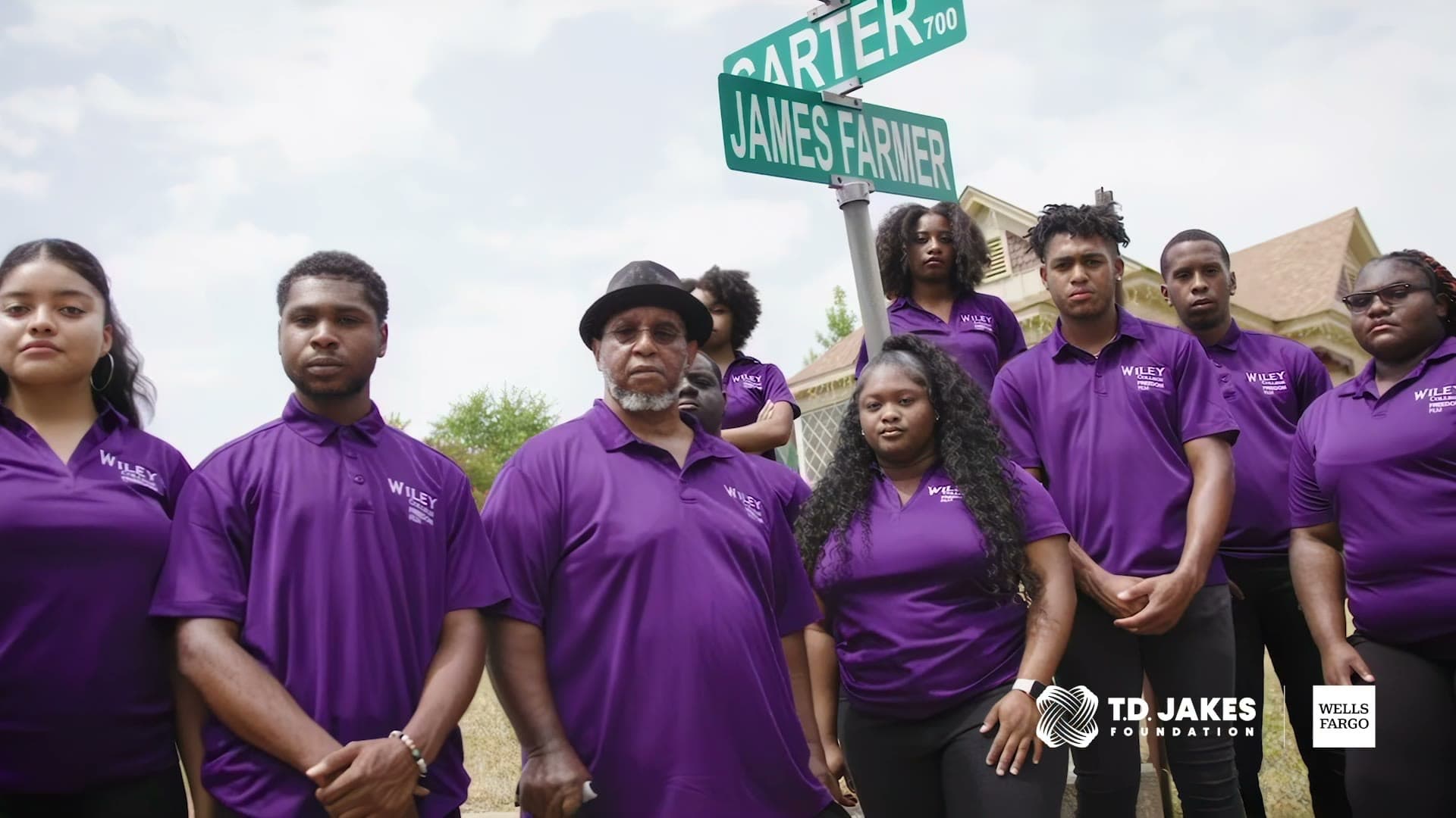 Wiley University students in purple on the corner of James Farmer street